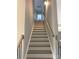 A long flight of stairs with oak treads and black iron railings at 143 Dabbling Duck Cir, Mooresville, NC 28117