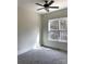 Carpeted bedroom with large window and ceiling fan offers abundant natural light at 148 Dabbling Duck Cir, Mooresville, NC 28117