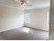 Neutral-toned bedroom with a ceiling fan, carpeted floors and natural light streaming in through two windows at 148 Dabbling Duck Cir, Mooresville, NC 28117