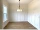 Elegant dining room featuring modern lighting, wainscoting, and hardwood floors at 148 Dabbling Duck Cir, Mooresville, NC 28117