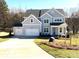 Charming two-story home with a three-car garage, manicured lawn, and inviting curb appeal at 148 Dabbling Duck Cir, Mooresville, NC 28117