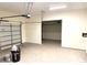 Spacious two car garage featuring an automatic door opener and unfinished concrete flooring at 148 Dabbling Duck Cir, Mooresville, NC 28117