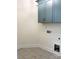 A neutral laundry room featuring diamond-patterned flooring and modern blue cabinets with gold hardware at 148 Dabbling Duck Cir, Mooresville, NC 28117