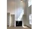 Elegant living room featuring a modern fireplace, soaring ceilings, and ample natural light at 148 Dabbling Duck Cir, Mooresville, NC 28117