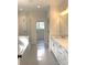 Well-lit main bathroom with double vanity, soaking tub and glass enclosed shower at 148 Dabbling Duck Cir, Mooresville, NC 28117