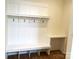 Well-organized mudroom featuring a bench, storage hooks, and a built-in desk area at 148 Dabbling Duck Cir, Mooresville, NC 28117