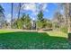 Beautifully landscaped backyard with lush green lawn and mature trees at 2315 Smith Harbour Dr, Denver, NC 28037