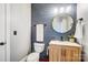 Stylish half bathroom features a modern vanity, wood paneled wall, and updated fixtures at 2315 Smith Harbour Dr, Denver, NC 28037