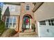 Close-up of a home's stone front entrance with an arched doorway, decorated with a festive holiday wreath at 2315 Smith Harbour Dr, Denver, NC 28037