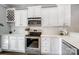 Well-equipped kitchen with stainless steel appliances, white cabinets, subway tile backsplash, and quartz countertops at 2315 Smith Harbour Dr, Denver, NC 28037