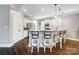 Spacious kitchen with a central island, bar seating, white cabinets, stainless steel appliances, and hardwood floors at 2315 Smith Harbour Dr, Denver, NC 28037