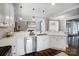 Bright kitchen featuring stainless steel appliances, white cabinetry, and views into an open concept living area at 2315 Smith Harbour Dr, Denver, NC 28037