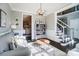 Inviting living room with a gray sofa, decorative pillows, stylish decor, and dark hardwood floors at 2315 Smith Harbour Dr, Denver, NC 28037