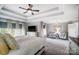 Comfortable main bedroom featuring tray ceiling, a seating area, and an ensuite bathroom at 2315 Smith Harbour Dr, Denver, NC 28037