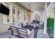 Inviting covered patio with ceiling fan, tv, cozy furniture, and string lights at 2315 Smith Harbour Dr, Denver, NC 28037