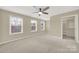 Bright bedroom with neutral walls, carpet, and ample closet space at 2471 Palmdale Walk Dr # 107, Fort Mill, SC 29708