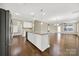 Open concept kitchen with island, stainless steel appliances, and hardwood floors at 2471 Palmdale Walk Dr # 107, Fort Mill, SC 29708