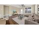 Living room with hardwood floors, sectional sofa, and glass top coffee table at 2471 Palmdale Walk Dr # 107, Fort Mill, SC 29708