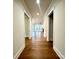 Bright hallway with hardwood floors and neutral paint at 2971 Alveston Nw Dr # 29, Concord, NC 28027