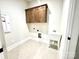 Functional laundry room with upper cabinets and a utility sink at 2971 Alveston Nw Dr # 29, Concord, NC 28027