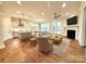 Well-lit and spacious open-concept living area featuring hardwood floors, modern lighting, and a fireplace at 2971 Alveston Nw Dr # 29, Concord, NC 28027