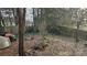 Backyard with wooden fence, overgrown landscaping, and shed at 6334 Dillard Ridge Dr, Charlotte, NC 28216