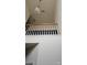Upper-level landing with geometric chandelier and railing at 6334 Dillard Ridge Dr, Charlotte, NC 28216