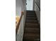 Carpeted staircase with wooden handrail leading upstairs at 6334 Dillard Ridge Dr, Charlotte, NC 28216