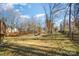 Spacious backyard with firepit and trees at 10221 Hanging Moss Trl, Mint Hill, NC 28227