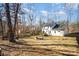 Large backyard with firepit and view of house at 10221 Hanging Moss Trl, Charlotte, NC 28227