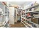 Large walk-in closet with shelving and hanging rods at 10221 Hanging Moss Trl, Mint Hill, NC 28227