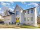 Two-story house with a yellow door, attached garage, and landscaping at 10221 Hanging Moss Trl, Charlotte, NC 28227