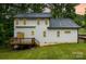 Back of house featuring a deck, sliding glass door, and fenced-in yard with mature trees at 10221 Hanging Moss Trl, Mint Hill, NC 28227
