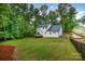 Fenced backyard with a well-maintained lawn and a deck perfect for outdoor entertainment at 10221 Hanging Moss Trl, Mint Hill, NC 28227