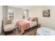 Comfortable bedroom with wood floors, natural light, and a neutral color palette at 10221 Hanging Moss Trl, Mint Hill, NC 28227