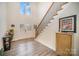 Inviting foyer featuring a soaring ceiling, wood-look floors, and a staircase with metal spindles at 10221 Hanging Moss Trl, Mint Hill, NC 28227