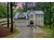 Charming two-story home featuring a modern design, two-car garage, and a long driveway at 10221 Hanging Moss Trl, Mint Hill, NC 28227