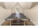 Game room with a ping pong table and natural light from the window at 10221 Hanging Moss Trl, Mint Hill, NC 28227