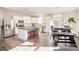 Modern kitchen featuring white cabinets, a large island, stainless steel appliances, and hardwood floors at 10221 Hanging Moss Trl, Mint Hill, NC 28227