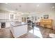 Spacious open-concept kitchen and dining area filled with natural light, featuring modern fixtures and stylish decor at 10221 Hanging Moss Trl, Mint Hill, NC 28227