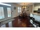 Bright dining area featuring a wooden table, bench seating, and a decorative chandelier at 18731 Ramsey Cove Dr # 72, Cornelius, NC 28031