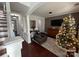 The living room features hardwood floors, ample lighting, neutral paint colors, and a Christmas tree at 18731 Ramsey Cove Dr # 72, Cornelius, NC 28031