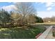 A fenced backyard with mature trees and a grassy area at 2505 Ashford Dr, Newton, NC 28658