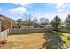 A spacious fenced backyard with mature trees and a grassy area at 2505 Ashford Dr, Newton, NC 28658