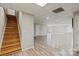 Finished basement featuring neutral walls, wood flooring, and a staircase leading to the upper level at 2505 Ashford Dr, Newton, NC 28658