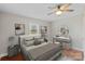 Staged bedroom with hardwood floors, a fan, and two piece of art above the bed at 2505 Ashford Dr, Newton, NC 28658