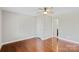 The bedroom features hardwood floors, ceiling fan and white trim and doors at 2505 Ashford Dr, Newton, NC 28658