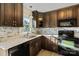 Well-equipped kitchen with stone backsplash, wood cabinets, and granite counters at 2505 Ashford Dr, Newton, NC 28658