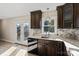 Kitchen area with black dishwasher, view of backyard and wood cabinets at 2505 Ashford Dr, Newton, NC 28658