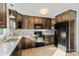 Kitchen boasts wood cabinets, granite countertops, and stainless-steel appliances at 2505 Ashford Dr, Newton, NC 28658